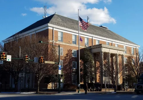 A large courthouse with trees out the front